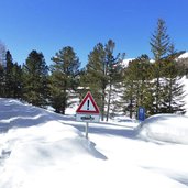 strassenschild und strasse im schnee winter